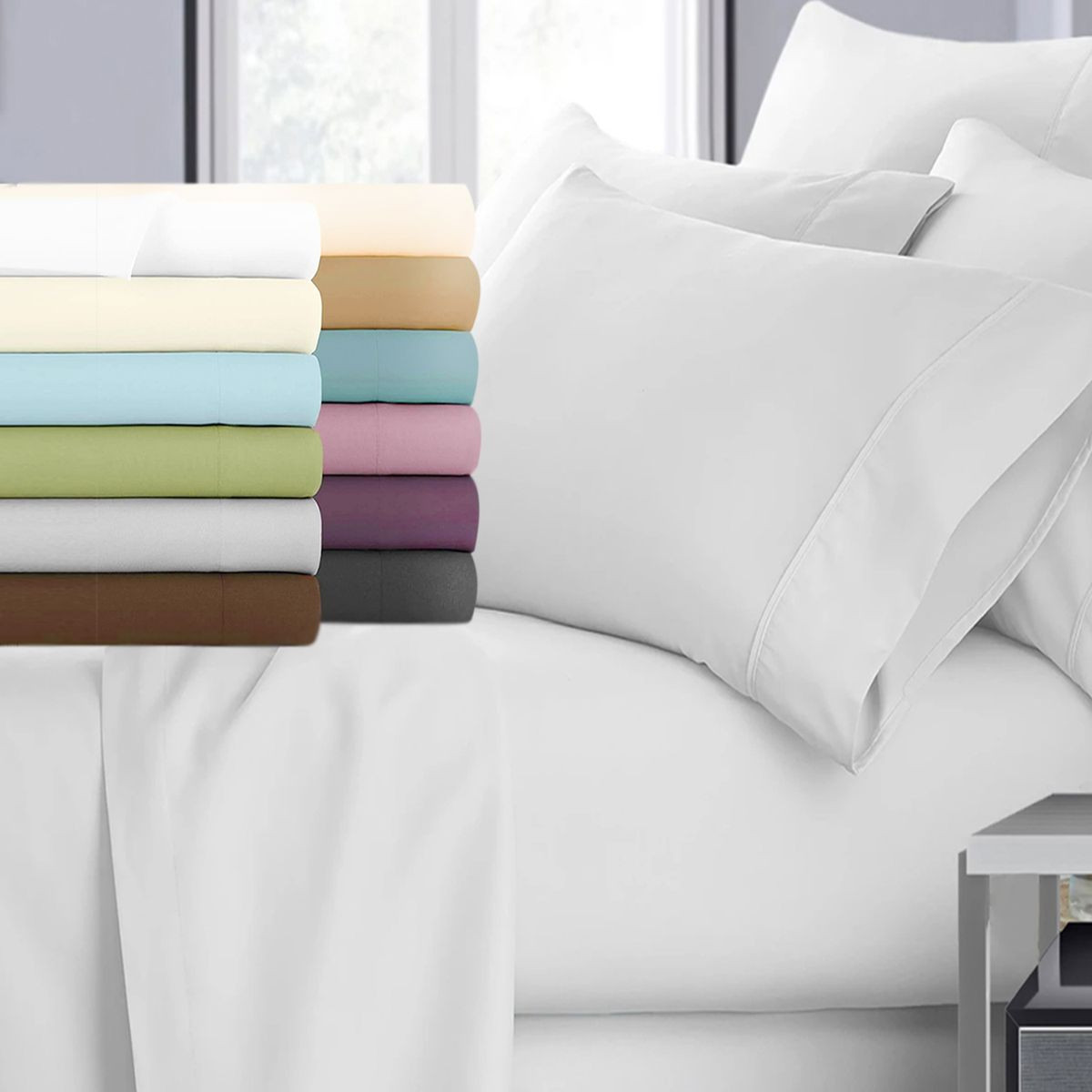 Multiple folded bedsheets in various colors, including white, cream, beige, blue, green, pink, purple, brown, and gray, are displayed next to a made bed with white sheets and pillows.