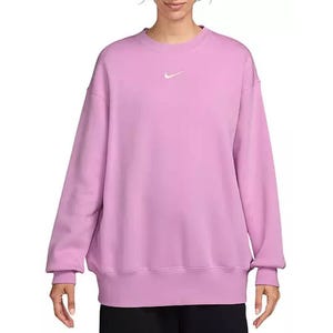 A person is wearing a light purple Nike sweatshirt with a small white Nike logo on the chest.