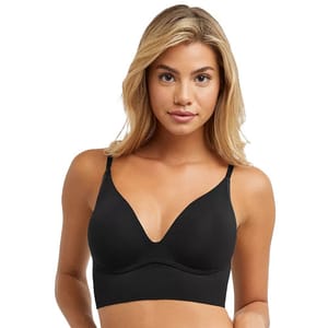 A woman wearing a black wireless bra with thin straps and a smooth, seamless design.