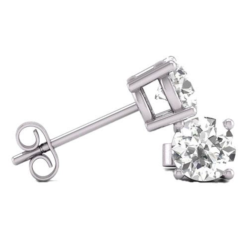 A pair of white gold stud earrings featuring round, clear gemstones in a prong setting, secured with butterfly backs.