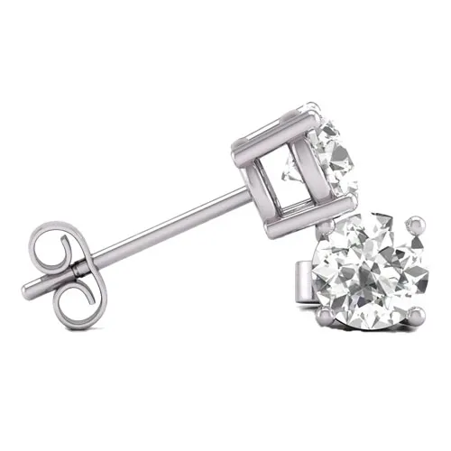 A pair of white gold stud earrings featuring round, clear gemstones in a prong setting, secured with butterfly backs.