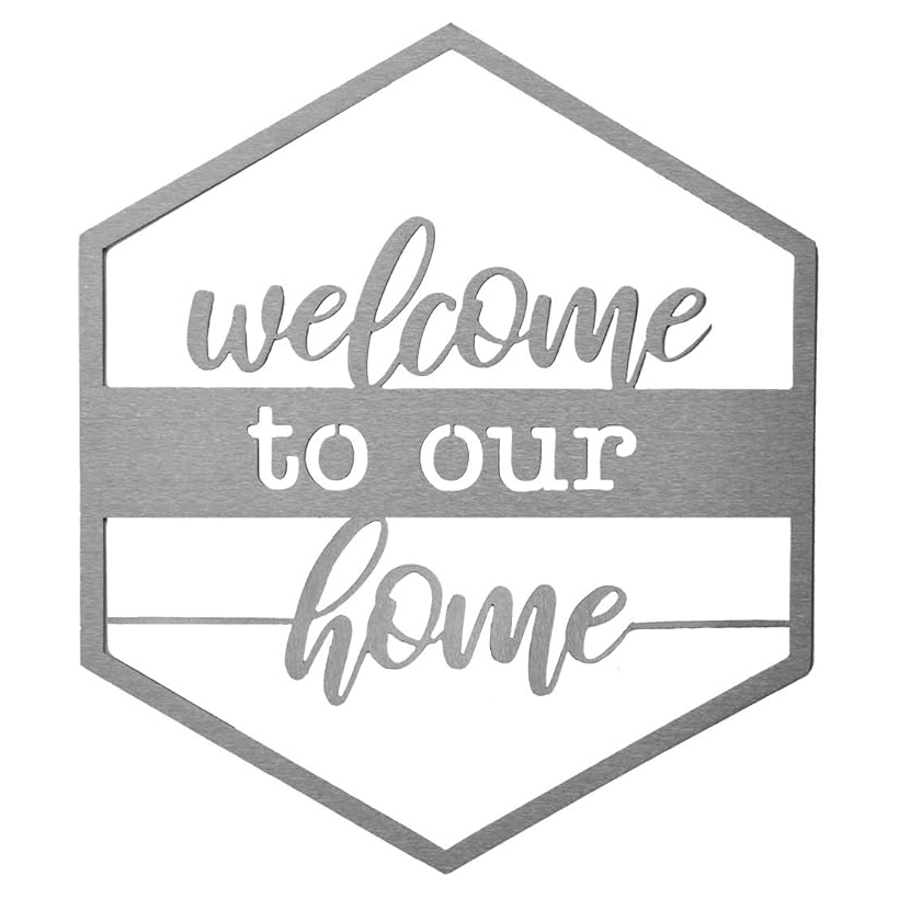 A hexagon-shaped metal door sign featuring the text \“welcome to our home\“ in a combination of script and print fonts.