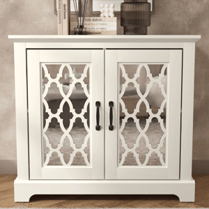 White cabinet with decorative mirrored doors, featuring a geometric pattern and black handles. Two books, an ornament, and a dark glass are placed on top.