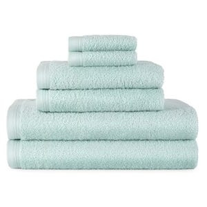 A stack of light blue towels in various sizes, with smaller towels on top and larger ones below, all featuring a textured design and bordered edges.