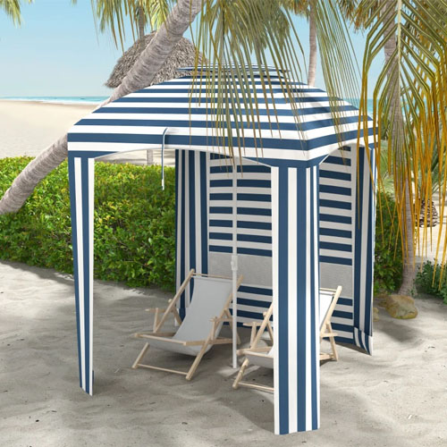 Blue and white striped beach cabana with two wooden deck chairs underneath.