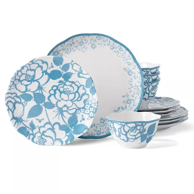 A dinnerware set with blue floral designs, including plates and bowls, featuring elegant patterns on a white background.
