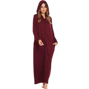 A woman wearing a long, maroon hooded cloak with pockets, ideal for cozy wear.