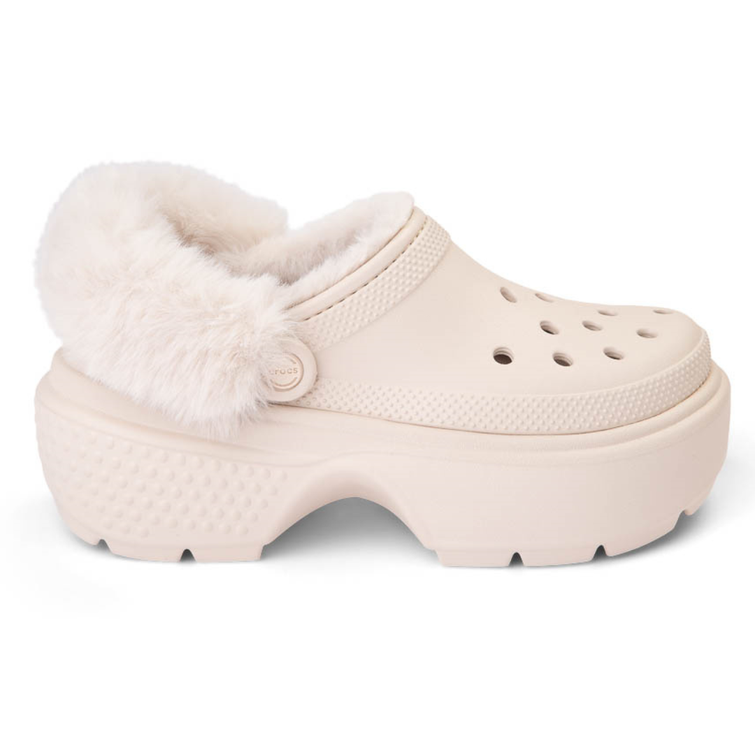Faux fur-lined beige clogs with platform soles and ventilation holes.