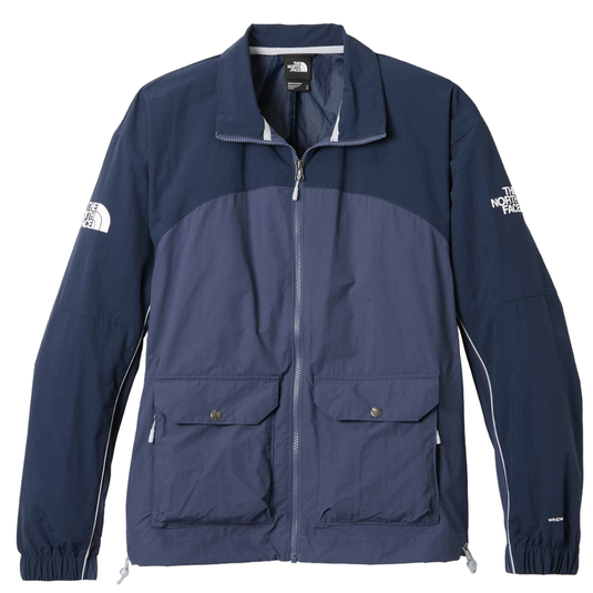 A two-tone blue The North Face windbreaker features a full zip, two front buttoned pockets, and logo branding on the front and sleeve.