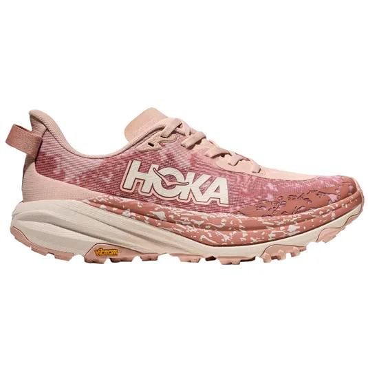 Hoka trail running shoe in pink tones with a textured sole and Vibram logo, featuring a textured pattern design and HOKA branding on the side.