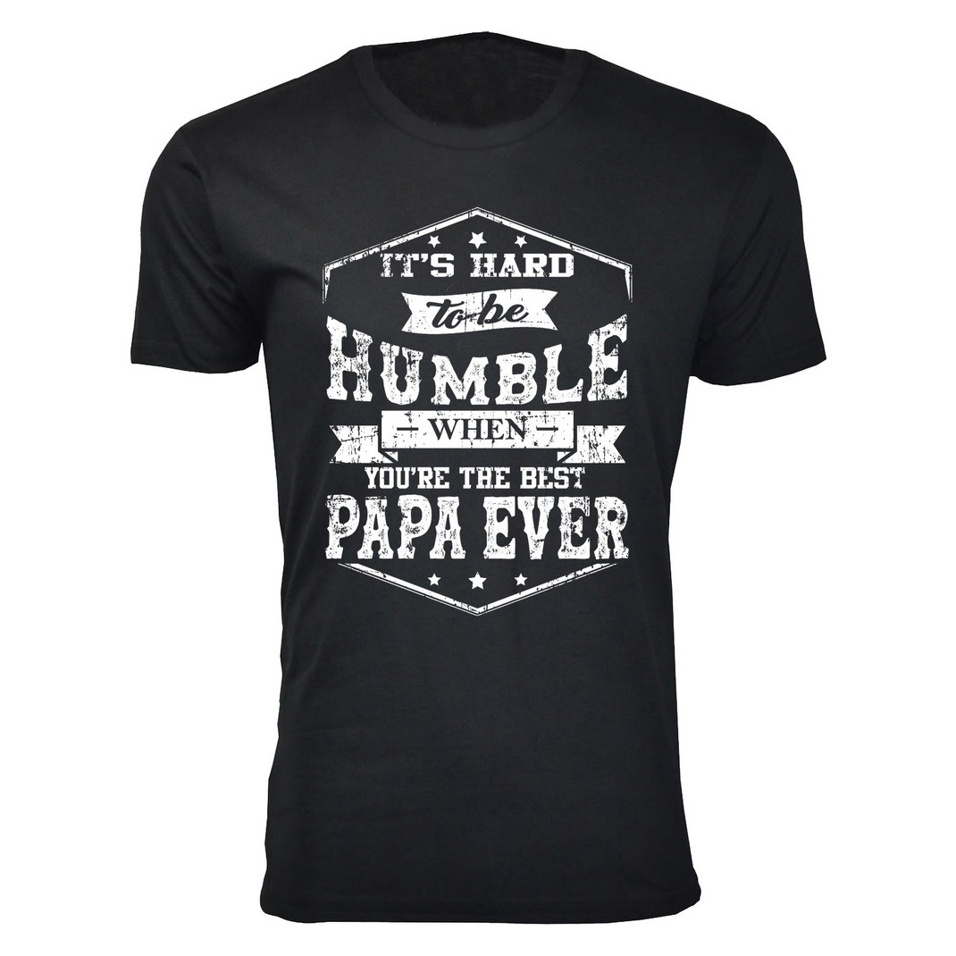 Black T-shirt with white text in various fonts: \“It's hard to be humble when you're the best Papa ever,\“ surrounded by decorative stars and lines.