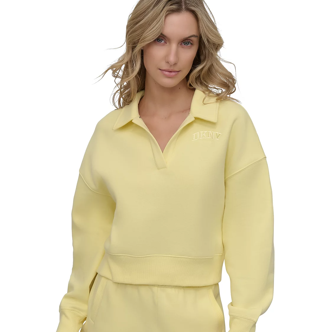 Yellow DKNY Johnny-Collar Pullover featuring a subtle collar, dropped shoulders, ribbed cuffs and hem, and the DKNY logo on the chest.