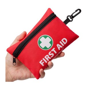 Red, zippered first aid pouch with a clip, labeled \“FIRST AID\“ and containing 110 pieces.