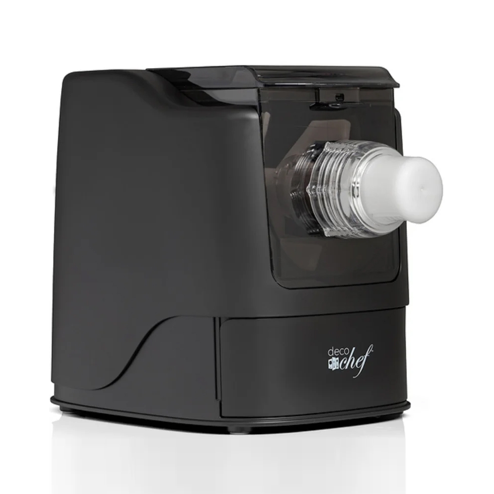 A black automatic pasta maker with a clear extruder attachment through which pasta can be seen being pressed. The brand name \“Deco Chef\“ is visible on the front.