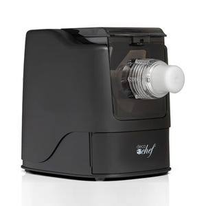A black automatic pasta maker with a clear extruder attachment through which pasta can be seen being pressed. The brand name \“Deco Chef\“ is visible on the front.