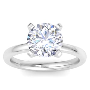 A 3-carat diamond solitaire ring set in a sleek platinum band. The round-cut diamond is held by four prongs, showcasing its brilliance and simplicity.