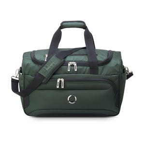 Green duffel bag with multiple zippers, a long adjustable shoulder strap, and short handles.