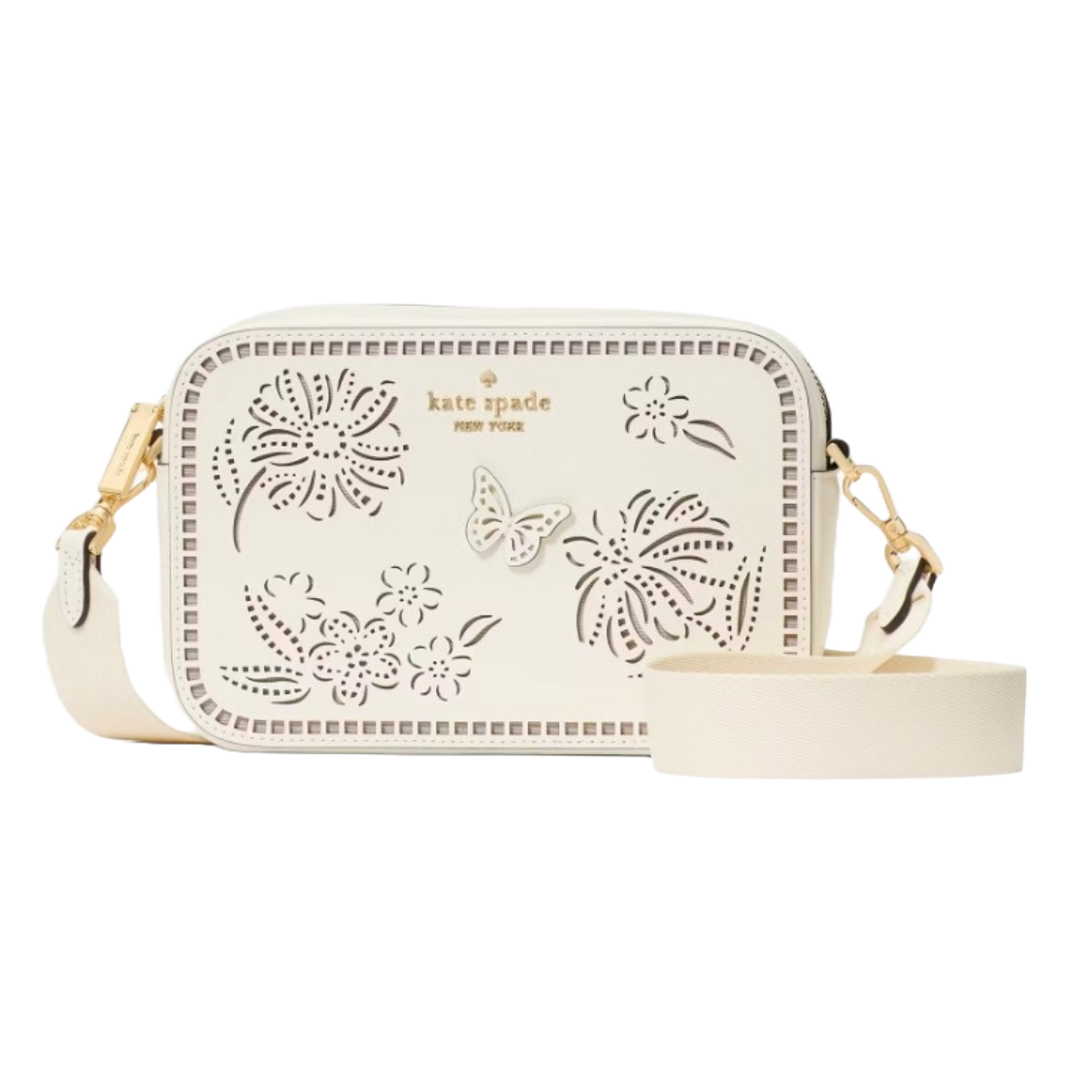 A white Kate Spade crossbody bag made from perforated leather, featuring floral and butterfly designs, gold hardware, and an adjustable strap.