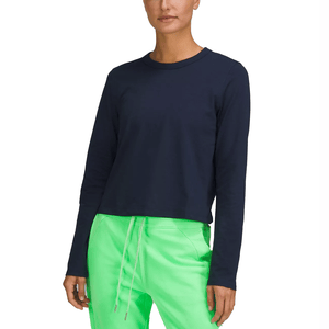 A navy long-sleeve top with a relaxed fit made from soft, stretchy fabric, paired with bright green drawstring pants.