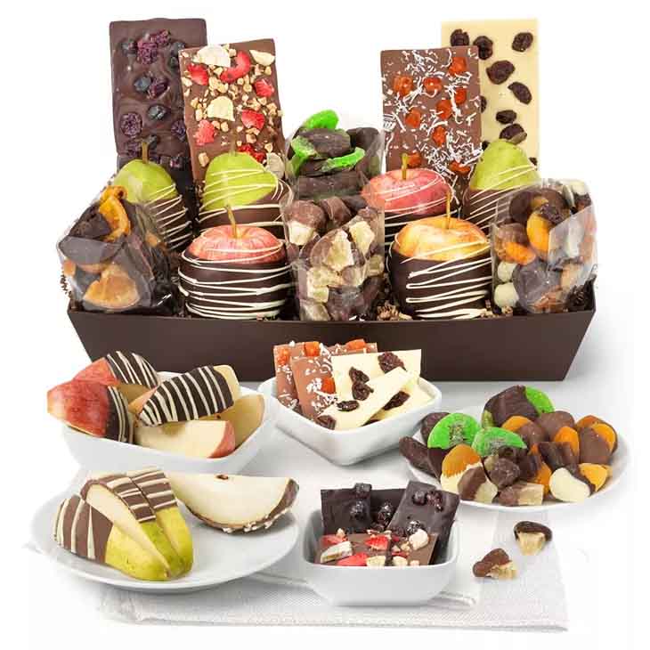 The Belgian Chocolate Divine Fruit Tray includes chocolate-dipped apples and pears, gourmet chocolate bars with nuts and fruit pieces, and a variety of chocolate-covered dried fruits arranged in a decorative brown tray.