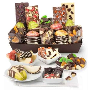 The Belgian Chocolate Divine Fruit Tray includes chocolate-dipped apples and pears, gourmet chocolate bars with nuts and fruit pieces, and a variety of chocolate-covered dried fruits arranged in a decorative brown tray.