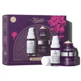 Kiehl's skincare set featuring Retinol Skin-Renewing Daily Micro-Dose Serum, Super Multi-Corrective Cream, and Eye Zone Treatment, packaged in a purple and pink box.