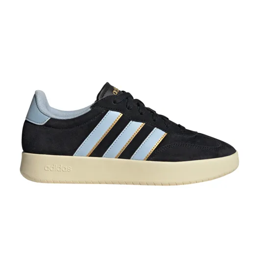 A black Adidas sneaker with light blue stripes, gold accents, and a beige sole.