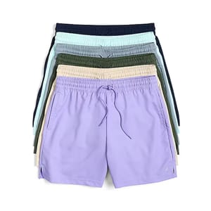 A stack of elastic-waisted drawstring shorts in various colors, including lavender, beige, green, and blue.