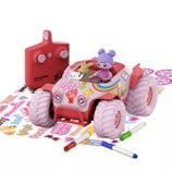 A remote-controlled toy car featuring colorful decals, driven by a figure with purple hair. Includes a set of stickers, markers, and a red remote labeled \“Pixie Cruiser.\“