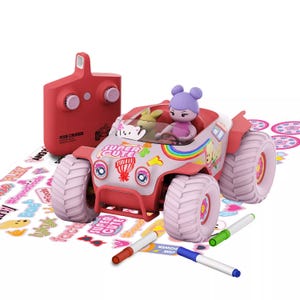 A remote-controlled toy car featuring colorful decals, driven by a figure with purple hair. Includes a set of stickers, markers, and a red remote labeled \“Pixie Cruiser.\“