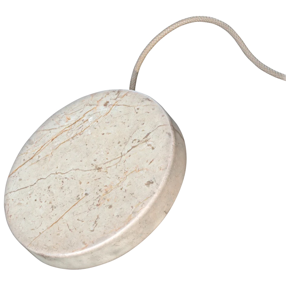A wireless charging stone with a marble-like design and a fabric-wrapped cable.