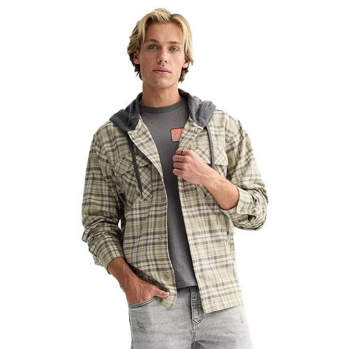 A man wearing a plaid shirt with a hood over a gray t-shirt and light gray jeans.