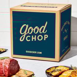 A box labeled \“Good Chop\“ suggests it contains high-quality meat, alongside raw meat cuts and grilled dishes.