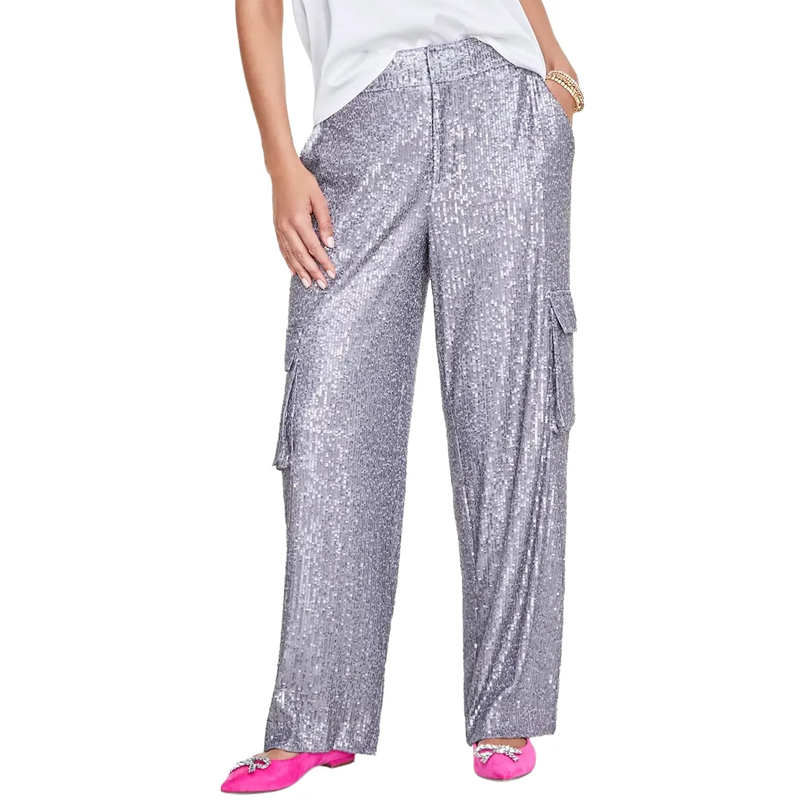 Silver sequin cargo pants with an elastic waistband, paired with vibrant pink embellished flat shoes.