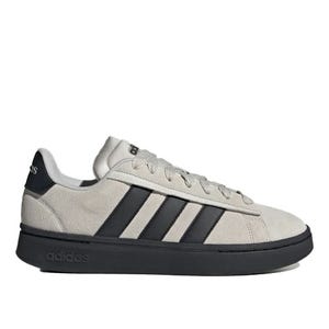 Adidas sneakers with a beige suede upper, black stripes, and a black sole.
