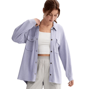 A juniors' shacket featuring a snap-front design, purple and white checkered pattern, long sleeves, and front chest pockets.