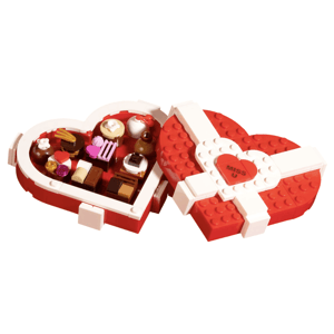 Heart-shaped LEGO box with chocolates, featuring \“MISS U\“ on the lid.