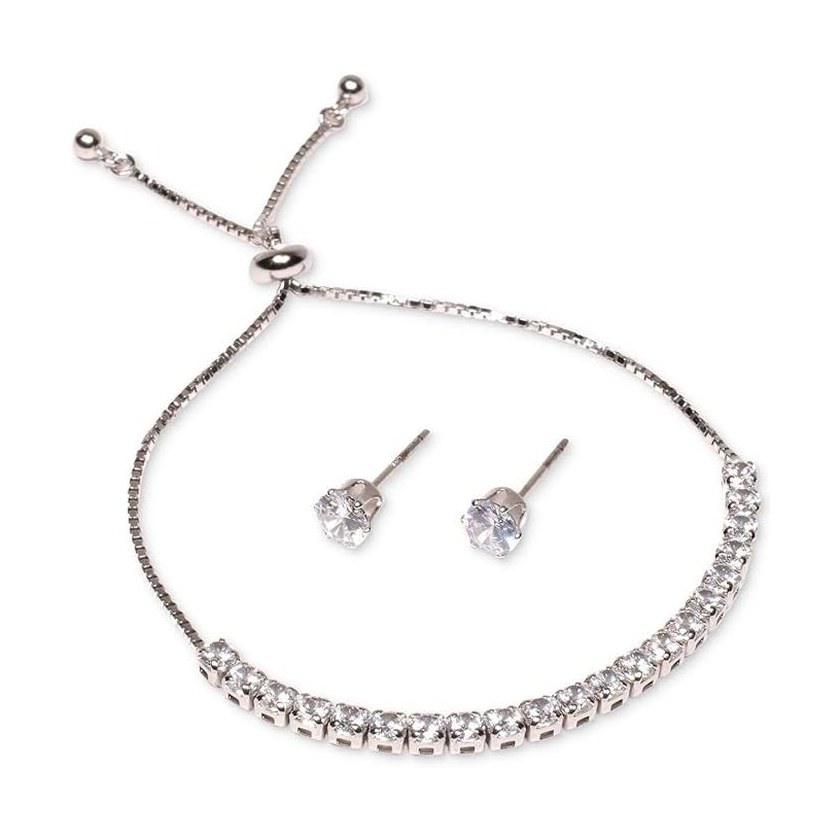A silver-tone bracelet with sparkling stones and a pair of matching stud earrings, featuring round clear gemstones.