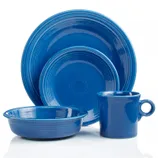 A blue dinnerware set includes a dinner plate, salad plate, bowl, and mug, each featuring a concentric circle design.
