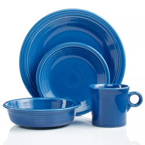 A blue dinnerware set includes a dinner plate, salad plate, bowl, and mug, each featuring a concentric circle design.