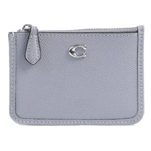 A compact, light grey Coach Mini Skinny ID Case with a pebbled leather texture, featuring a zippered top closure and a small metal \“C\“ logo on the front.