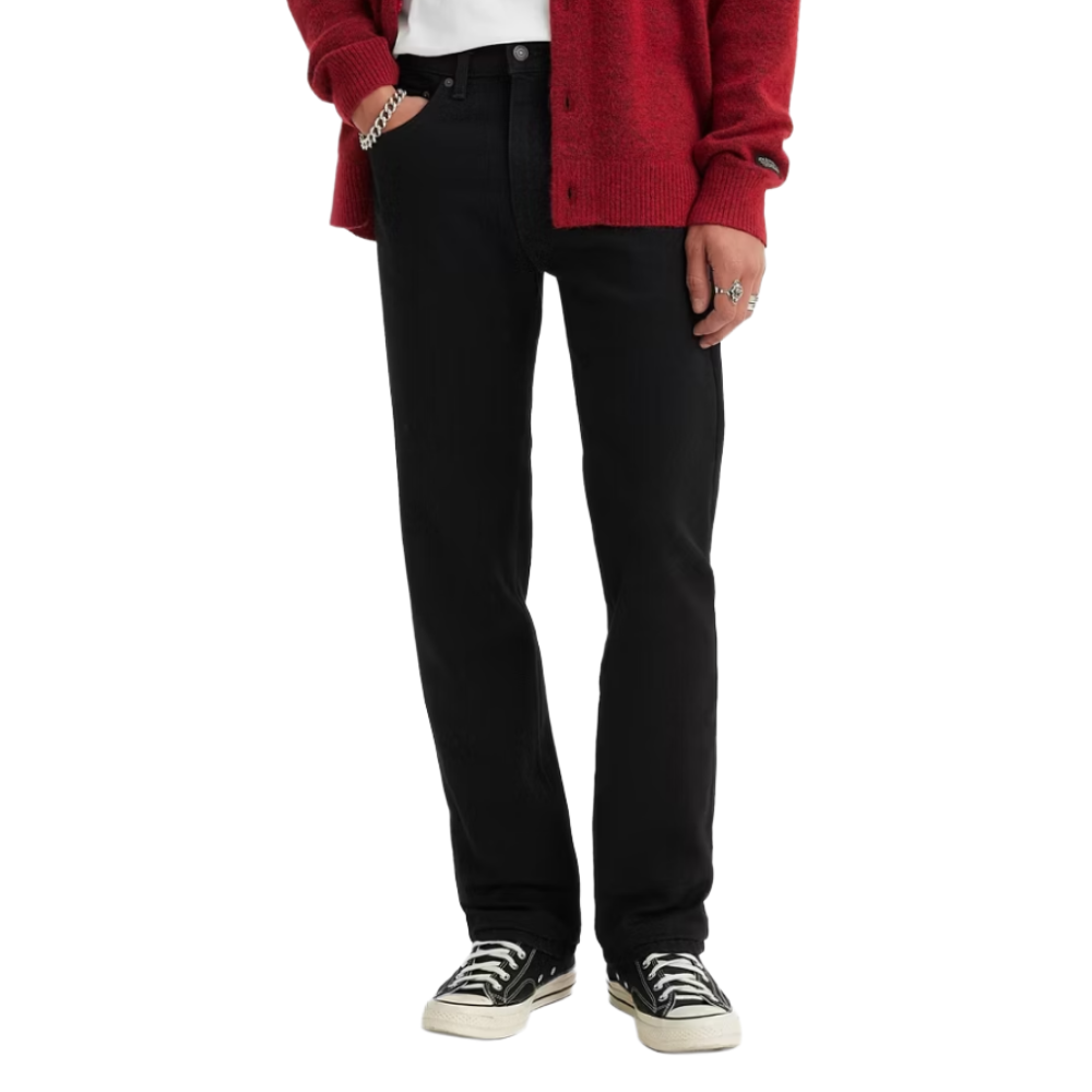 A person is wearing black straight-leg jeans, a white T-shirt, a red cardigan, and black high-top sneakers with white laces.