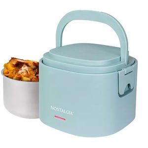 A light blue portable electric lunch box with a handle, designed for heating food, displayed with a metal food container filled with mac and cheese.