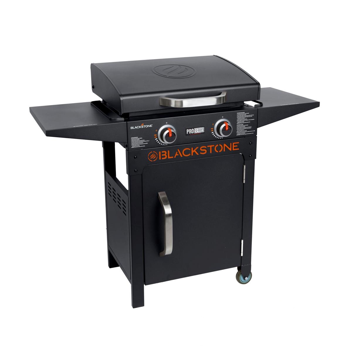 Blackstone 22\“ Griddle Set with two burners, black cabinet, side shelves, and a stainless steel handle on the front door. Designed for outdoor cooking with a sleek, compact design.