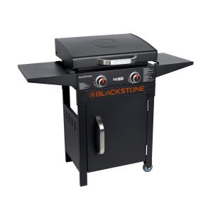 Blackstone 22\“ Griddle Set with two burners, black cabinet, side shelves, and a stainless steel handle on the front door. Designed for outdoor cooking with a sleek, compact design.