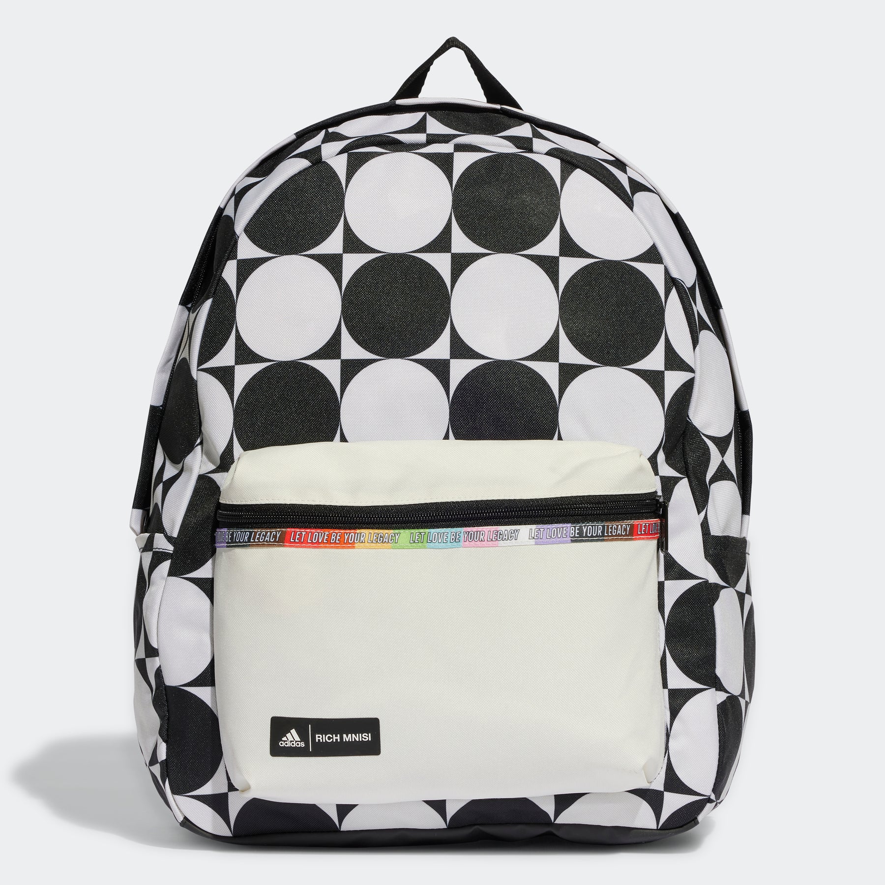 A backpack with a bold black and white geometric pattern and a beige front pocket, accented with a branded strap detail.