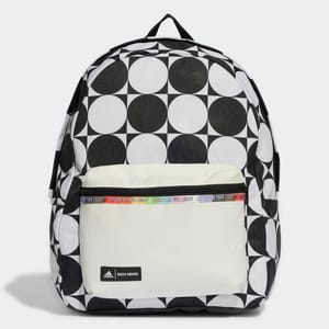 A backpack with a bold black and white geometric pattern and a beige front pocket, accented with a branded strap detail.