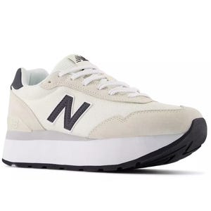 New Balance sneaker featuring a white mesh upper, beige suede accents, and a raised black sole. The shoe displays the iconic 'N' logo on the side.