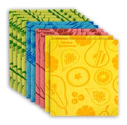 A stack of colorful Swedish dishcloths in various patterns including fruits and botanical designs, in yellow, pink, blue, and green shades.
