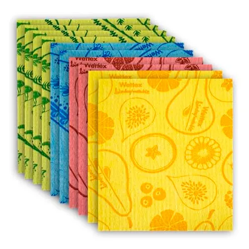 A stack of colorful Swedish dishcloths in various patterns including fruits and botanical designs, in yellow, pink, blue, and green shades.